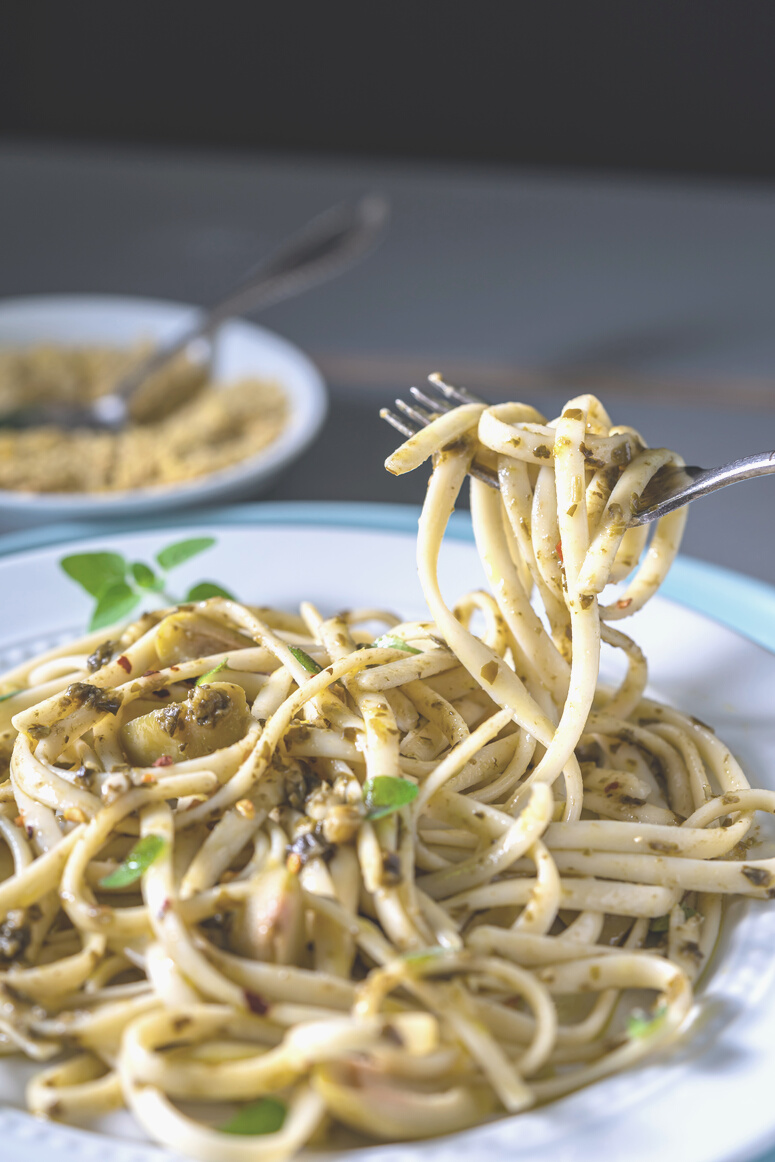 Vegan, fettuccine with green olives and pesto. Side dish with Nutritional yeast.